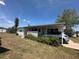 Inviting single-story home featuring a covered carport and a neat, well-kept lawn, ideal for easy living at 6882 Holo Ct, North Port, FL 34287