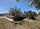 Corner view showcasing the single-story home's exterior, complemented by a manicured lawn and a covered carport at 6882 Holo Ct, North Port, FL 34287