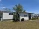 Exterior angle of a single-story residence with a covered parking spot surrounded by a well-kept lawn at 6882 Holo Ct, North Port, FL 34287