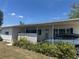 A cozy home featuring a covered parking space and inviting front yard greenery at 6882 Holo Ct, North Port, FL 34287