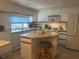 Bright eat-in kitchen featuring a center island, modern appliances, and lots of cabinet storage at 6882 Holo Ct, North Port, FL 34287