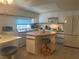 Bright eat-in kitchen featuring a center island, modern appliances, and lots of cabinet storage at 6882 Holo Ct, North Port, FL 34287
