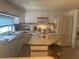 Bright eat-in kitchen featuring a center island, modern appliances, and lots of cabinet storage at 6882 Holo Ct, North Port, FL 34287