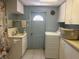Laundry room features cabinetry, a sink, and a white washing machine at 6882 Holo Ct, North Port, FL 34287