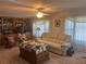 Inviting living room featuring a built-in bookcase, comfortable sofa, and book-laden coffee table at 6882 Holo Ct, North Port, FL 34287
