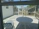 Screened-in patio with an outdoor dining table and a lounge chair at 6882 Holo Ct, North Port, FL 34287