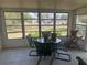 Bright sun room with tile flooring and outdoor views through the expansive windows at 6882 Holo Ct, North Port, FL 34287