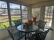 Enclosed sun room with tile flooring and outdoor views through the large windows at 6882 Holo Ct, North Port, FL 34287