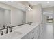 Bathroom featuring double vanity with modern fixtures and an oversized mirror at 7116 Quarry St, Englewood, FL 34224