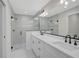 Modern bathroom featuring double vanity, sleek fixtures, and glass-enclosed shower with tiled walls at 7116 Quarry St, Englewood, FL 34224