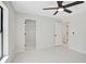 Large bright bedroom with ceiling fan, closet, and an open doorway to another room at 7116 Quarry St, Englewood, FL 34224