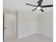 Bedroom featuring a ceiling fan, closet and view to en-suite bathroom at 7116 Quarry St, Englewood, FL 34224