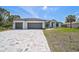 Beautiful single-story home featuring a three-car garage and a meticulously paved driveway at 7116 Quarry St, Englewood, FL 34224