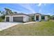Charming single-Gathering home featuring a two-car garage, well-manicured lawn, and neutral tones at 7116 Quarry St, Englewood, FL 34224