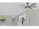 Open-concept kitchen with stainless steel appliances, modern white cabinetry, and a center island at 7116 Quarry St, Englewood, FL 34224