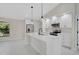 Bright kitchen with white cabinetry, stainless steel appliances, and center island with pendant lighting at 7116 Quarry St, Englewood, FL 34224
