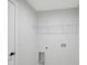 Functional laundry room with shelving and hookups for a washer and dryer, ready for customization at 7116 Quarry St, Englewood, FL 34224