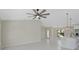 Spacious living area open to kitchen, complete with modern ceiling fan and sleek tile floors at 7116 Quarry St, Englewood, FL 34224