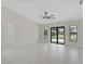 Bright living room featuring a ceiling fan, tile floors, and sliding doors to a private pool at 7116 Quarry St, Englewood, FL 34224