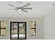 Living room features a ceiling fan, natural light, and sliding door leading to the pool at 7116 Quarry St, Englewood, FL 34224