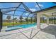 Relaxing screened-in pool and spa with a spacious covered patio area, perfect for entertaining at 7116 Quarry St, Englewood, FL 34224