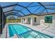 Enclosed screened in pool and spa area with clear blue skies at 7116 Quarry St, Englewood, FL 34224