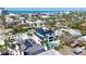 Aerial view of a luxurious home with a rooftop deck, a pool, and lush landscaping at 723 S Blvd Of The Presidents, Sarasota, FL 34236