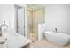Modern bathroom featuring a walk-in shower, a soaking tub, and a stylish vanity at 723 S Blvd Of The Presidents, Sarasota, FL 34236