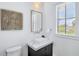 Modern half-bath features stylish vanity with a square sink and contemporary artwork at 723 S Blvd Of The Presidents, Sarasota, FL 34236