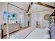 Spacious bedroom with a vaulted ceiling, stylish furnishings, and seamless bathroom access at 723 S Blvd Of The Presidents, Sarasota, FL 34236