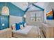 Stylish bedroom with a vaulted ceiling, custom blue accent wall, and coordinated decor at 723 S Blvd Of The Presidents, Sarasota, FL 34236