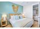 Comfortable bedroom with a light blue accent wall, rattan headboard, and matching side tables at 723 S Blvd Of The Presidents, Sarasota, FL 34236
