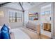 Well-lit bedroom with vaulted ceilings, coordinated decor, and bathroom access at 723 S Blvd Of The Presidents, Sarasota, FL 34236
