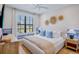 Bright bedroom featuring a king bed, stylish decor, and a large window with natural light at 723 S Blvd Of The Presidents, Sarasota, FL 34236