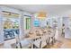 Bright dining area with seating for eight and sliding glass doors to the outdoors at 723 S Blvd Of The Presidents, Sarasota, FL 34236
