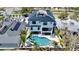 Modern, three-story home featuring a rooftop deck, open patio, pool with a slide, and beautiful landscaping at 723 S Blvd Of The Presidents, Sarasota, FL 34236