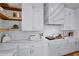 Well-appointed kitchen features designer countertops, stainless steel appliances, and open shelving at 723 S Blvd Of The Presidents, Sarasota, FL 34236