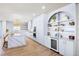 Bright, open kitchen with a waterfall island, custom cabinets, and wine fridge at 723 S Blvd Of The Presidents, Sarasota, FL 34236