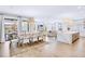 Open-concept living space with dining area, kitchen island and lots of natural light at 723 S Blvd Of The Presidents, Sarasota, FL 34236