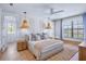 Serene main bedroom featuring stylish pendant lighting, ceiling fan, and decorative trim at 723 S Blvd Of The Presidents, Sarasota, FL 34236