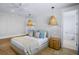 Comfortable main bedroom with pendant lighting, a ceiling fan, and a glimpse of the bathroom at 723 S Blvd Of The Presidents, Sarasota, FL 34236