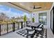 Outdoor patio with black metal railings, wood ceiling, fan and outdoor seating for 6 at 723 S Blvd Of The Presidents, Sarasota, FL 34236