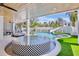 Covered patio area with a unique water feature, lounge seating, and an outdoor slide at 723 S Blvd Of The Presidents, Sarasota, FL 34236