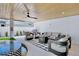 Covered patio area offering a cozy seating arrangement, outdoor grill, and relaxing ambiance at 723 S Blvd Of The Presidents, Sarasota, FL 34236