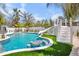 Inviting swimming pool with a built-in table, water slide, and well-manicured surroundings at 723 S Blvd Of The Presidents, Sarasota, FL 34236
