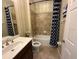 Bathroom featuring a tub and shower combination, a vanity, and decorative wallpaper at 7360 Talon Bay Dr, North Port, FL 34287