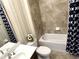 Full bathroom featuring a single sink vanity, a toilet, and a shower-tub combination with tiled surround at 7360 Talon Bay Dr, North Port, FL 34287
