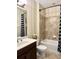 Full bathroom featuring a single sink vanity, a toilet, and a shower-tub combination with tiled surround at 7360 Talon Bay Dr, North Port, FL 34287
