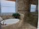 This primary bath showcases a soaking tub, a separate shower, and elegant tile work at 7360 Talon Bay Dr, North Port, FL 34287