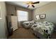 Bright bedroom with two twin beds, a chest of drawers, and a window providing natural light at 7360 Talon Bay Dr, North Port, FL 34287